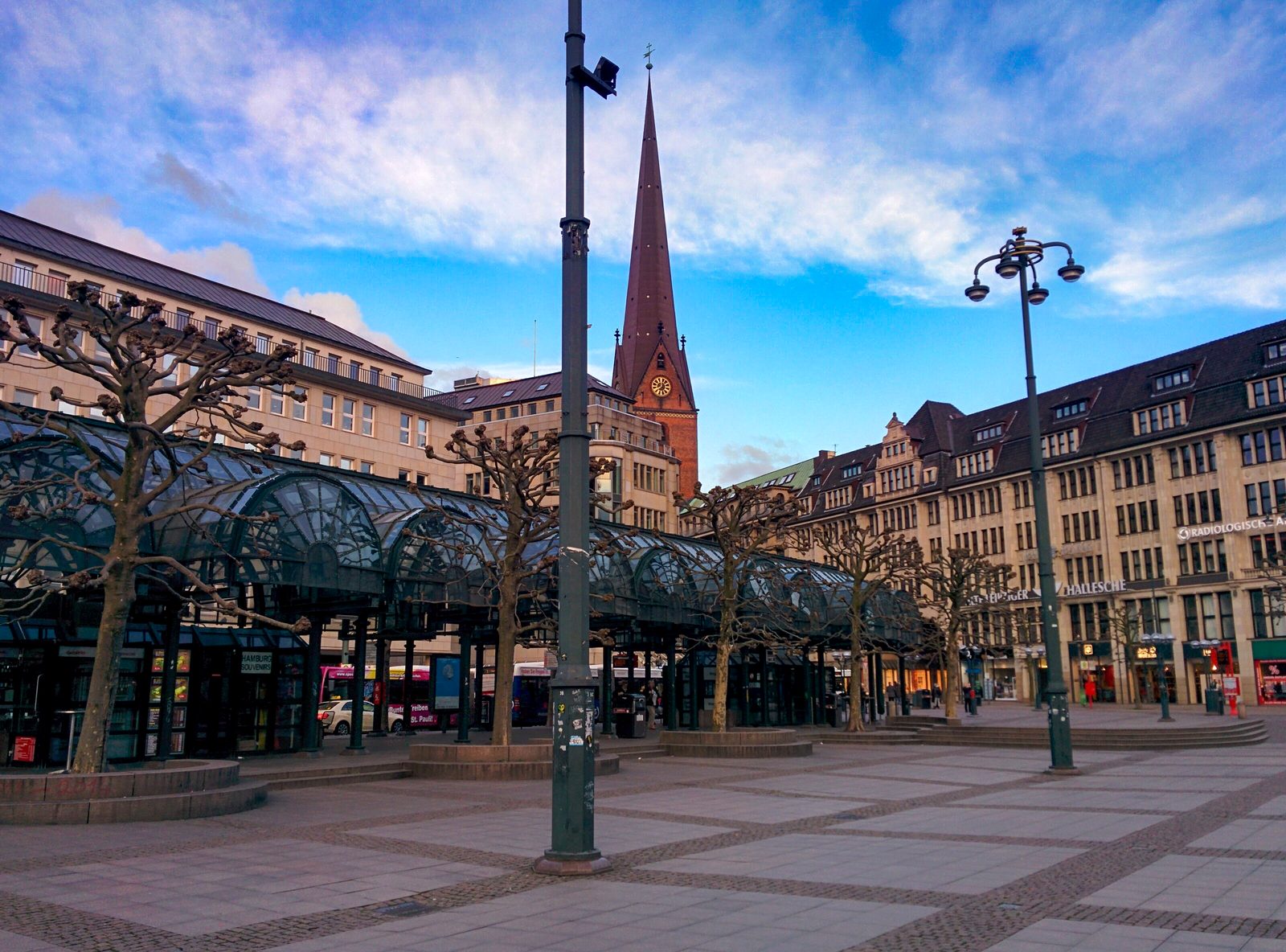 A city square with a passing tram