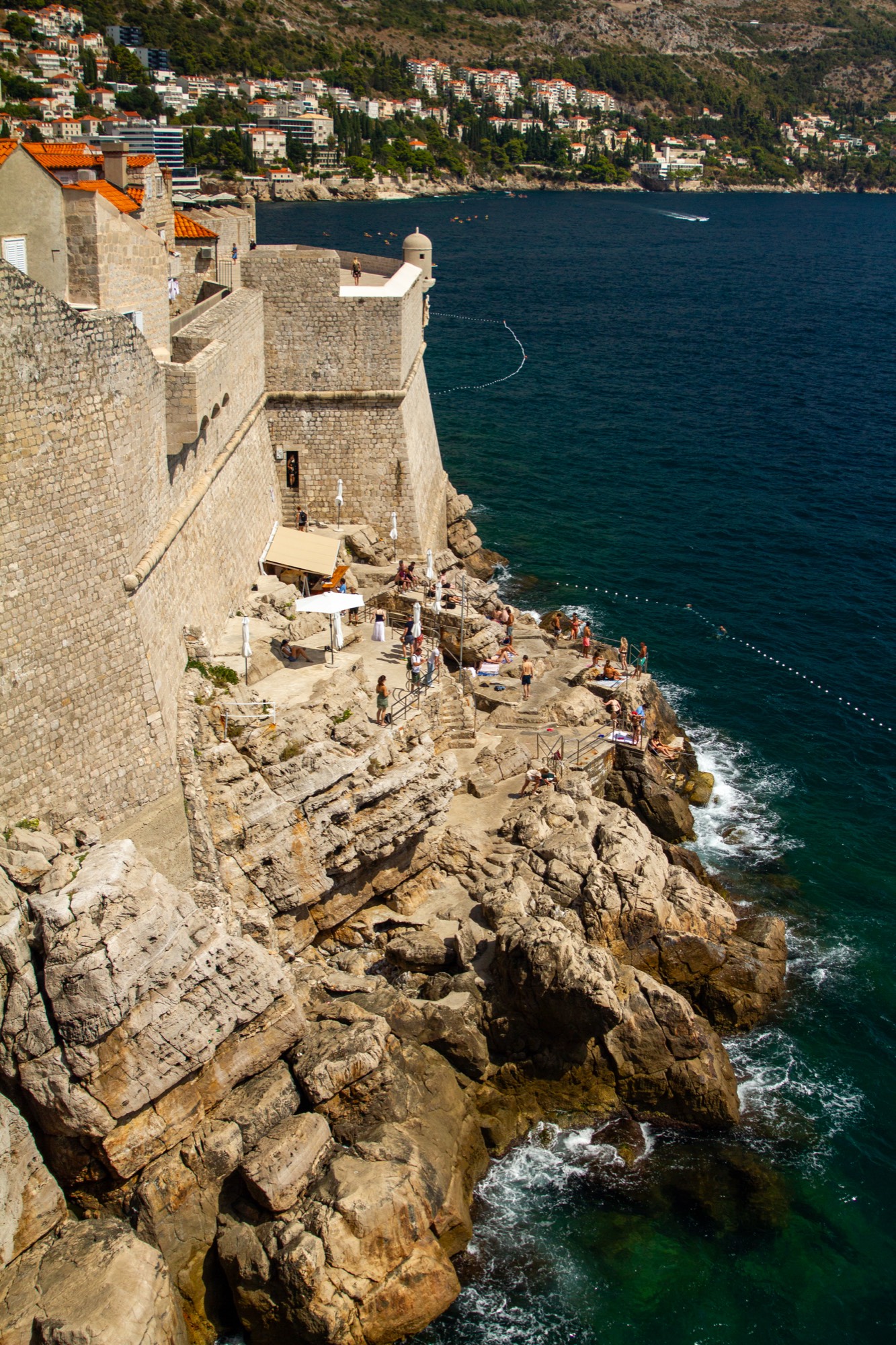 Swimmers beneath the ancient walls